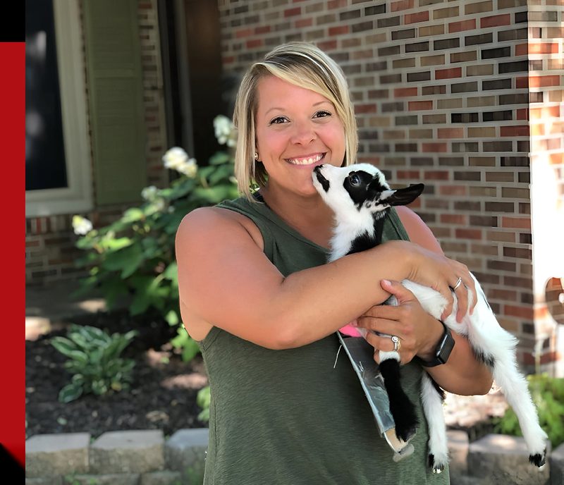 Mary Jordan holding a baby goat