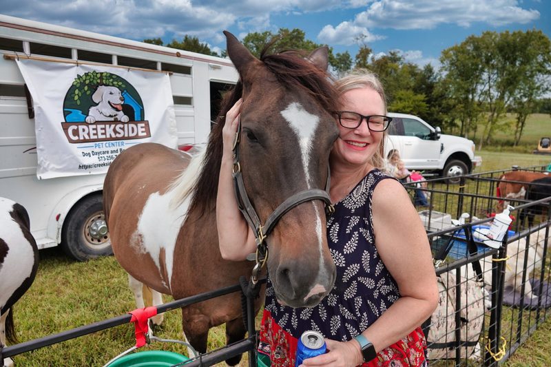 A guest enjoying the petting corral at Farm Day
