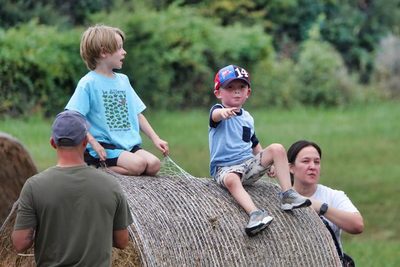 Kids climbing hay bales at Farm Day