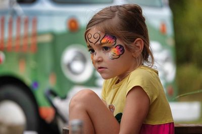 A young guest showing off her face paint at Farm Day