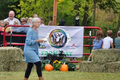 The Farm Day welcome banner with hay bales and pumpkins
